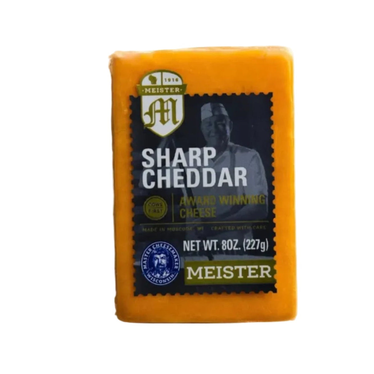 Block of Meister Sharp Cheddar cheese on a white background