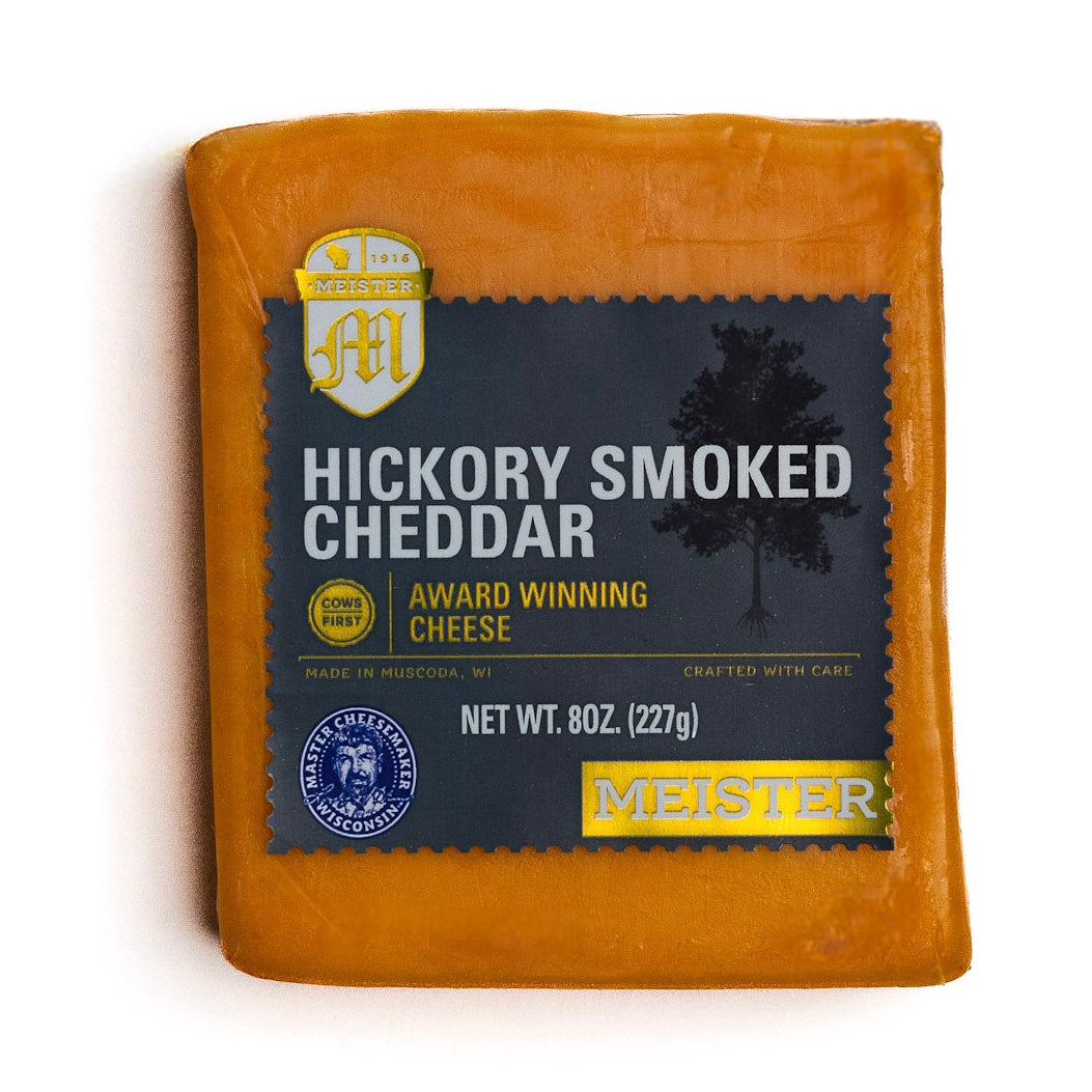 Packaged Meister hickory smoked cheddar cheese on a white background