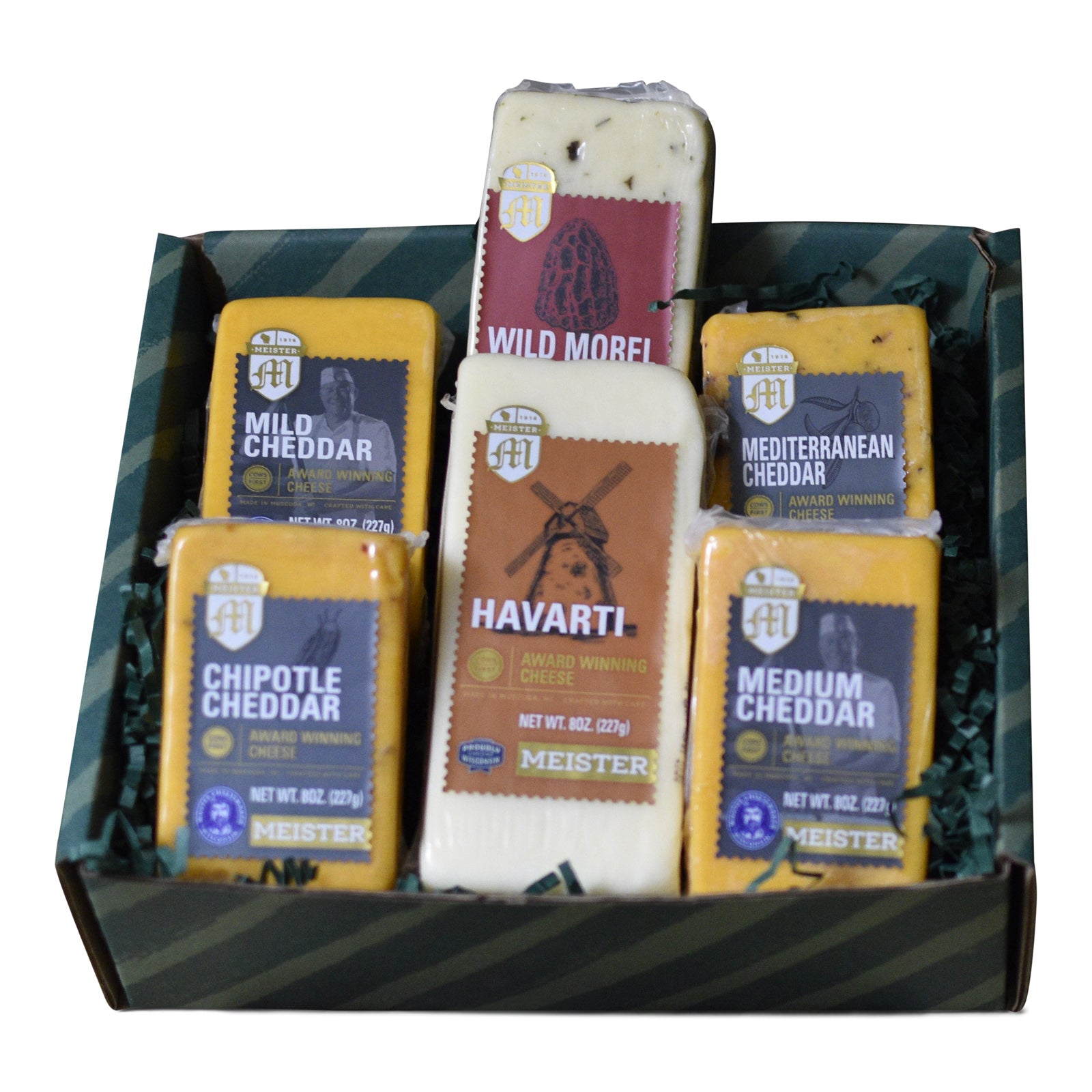 A selection of Meister cheese varieties arranged in a box, including Chipotle Cheddar, Havarti, Mediterranean Cheddar, Medium Cheddar, Mild Cheddar, and Wild Morel & Leek Jack.